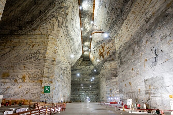 From Bucharest: Largest Salt Mine in Europe and Peles Castle - Unirea Salt Mine: 208 meters down in huge trapezoidal chambers