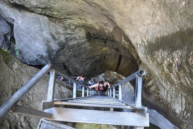 Small-Group Day Trip to the Epic 7 Ladders Canyon from Brasov - Entering Canionul Sapte Scari: ladders, bridges, and waterfall views up close